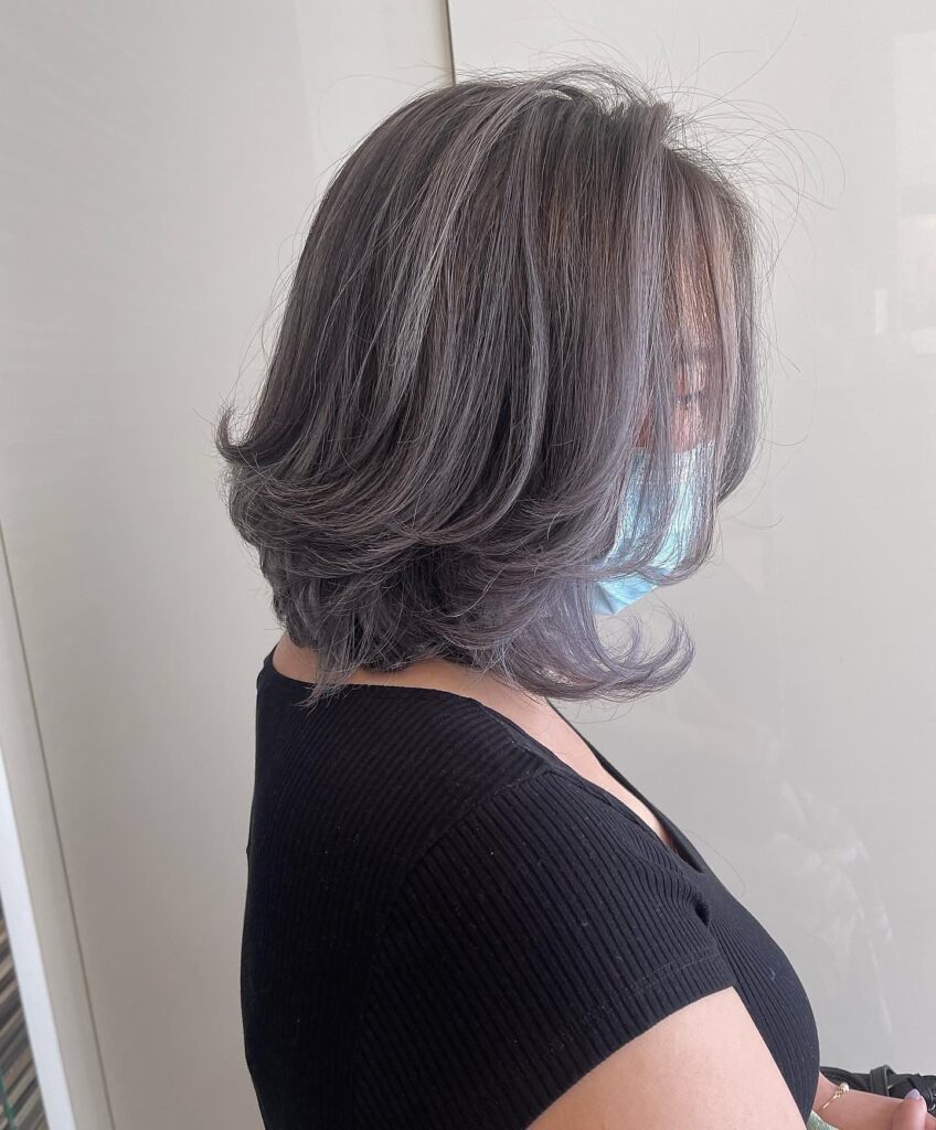 Smoky gray layered bob with soft silver highlights and feathered ends.