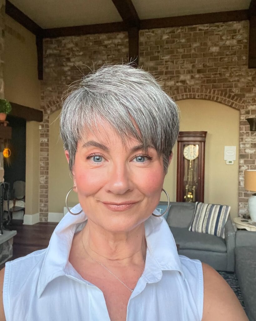 Short silver-gray pixie haircut with soft layers, a textured crown, and a side-swept fringe that gently frames the face.