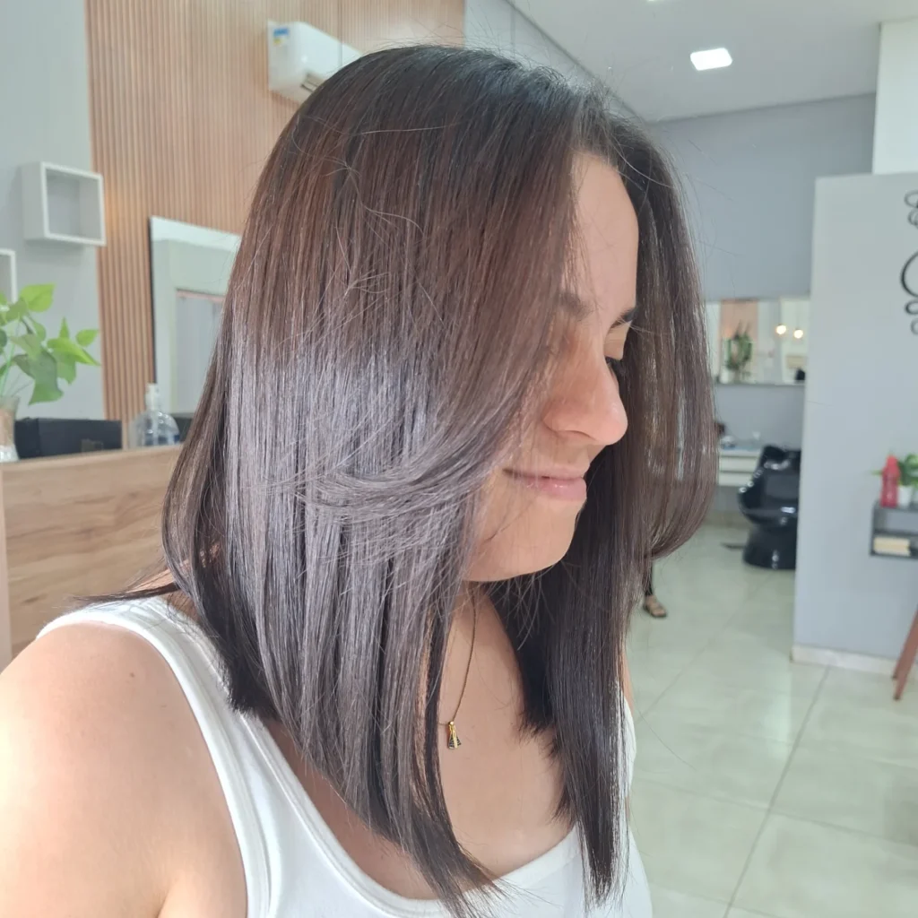 Shoulder-length straight lob with soft layered ends and a subtle side part, styled smooth and sleek for a polished finish.