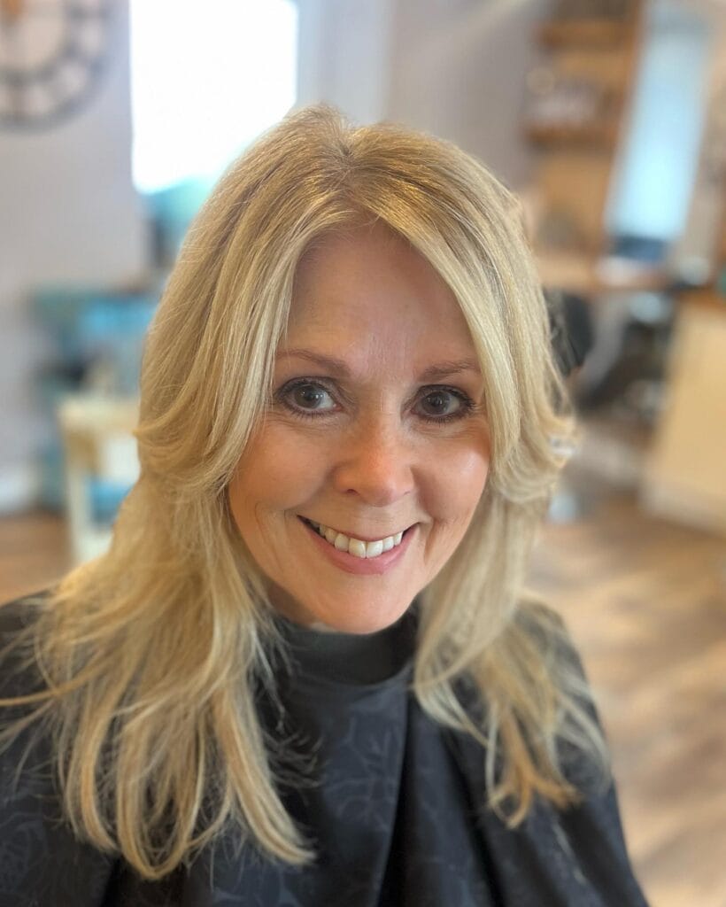 Shoulder-length blonde shag haircut with soft, choppy layers and feathered ends, styled with light volume and face-framing pieces for a fresh, airy look.