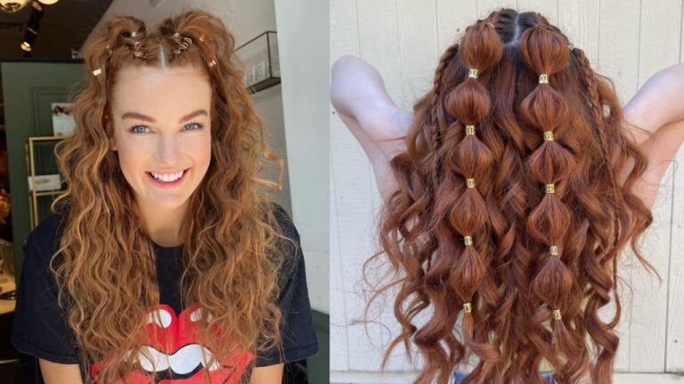 A woman with long, curly auburn hair styled with small gold hair cuffs — two mini buns at the crown and a grid-like bubble braid pattern cascading down the back.
