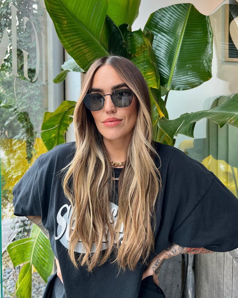 Long wavy hair with a center part and soft beachy texture.