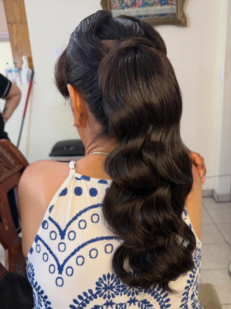 Dark hair styled into a sleek bubble ponytail with evenly spaced sections.
