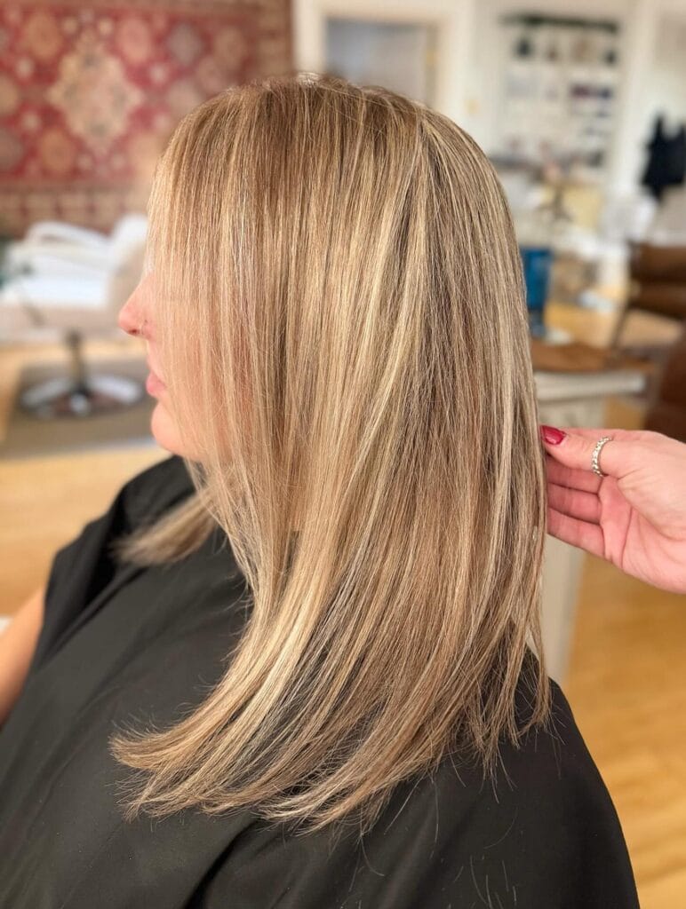 Long straight blonde hair with subtle layers and clean polished ends.