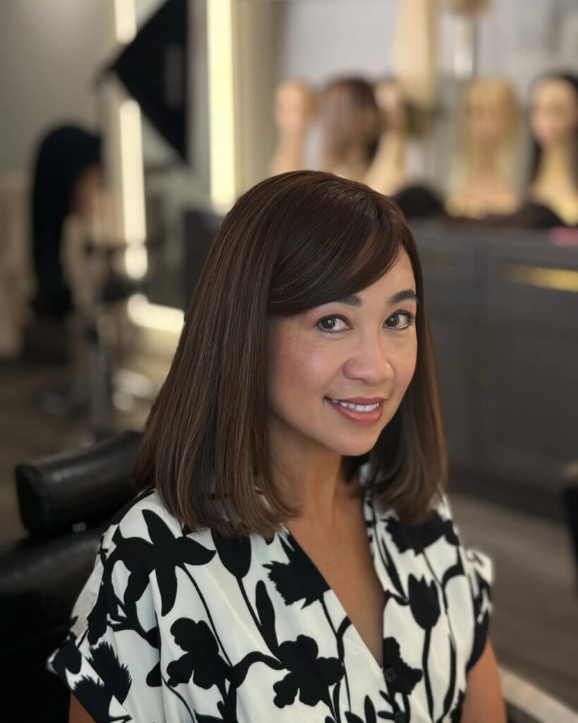 Chin-length straight brunette bob with soft side bangs.