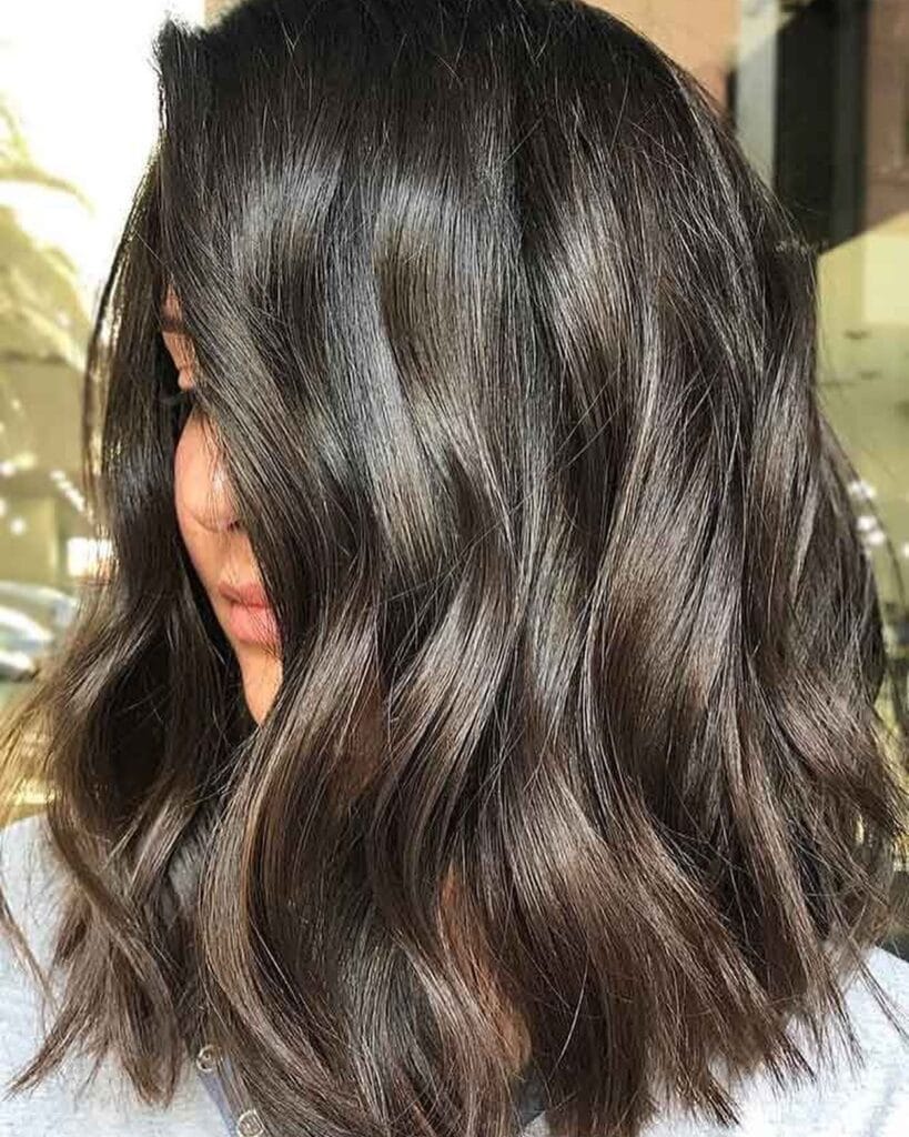 Medium-length brunette wavy hair with soft natural movement.