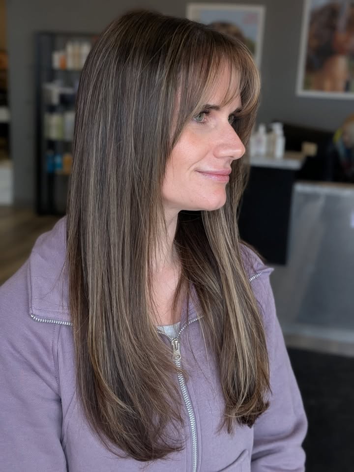 Long straight light brown hair with soft side bangs blended into layered lengths.
