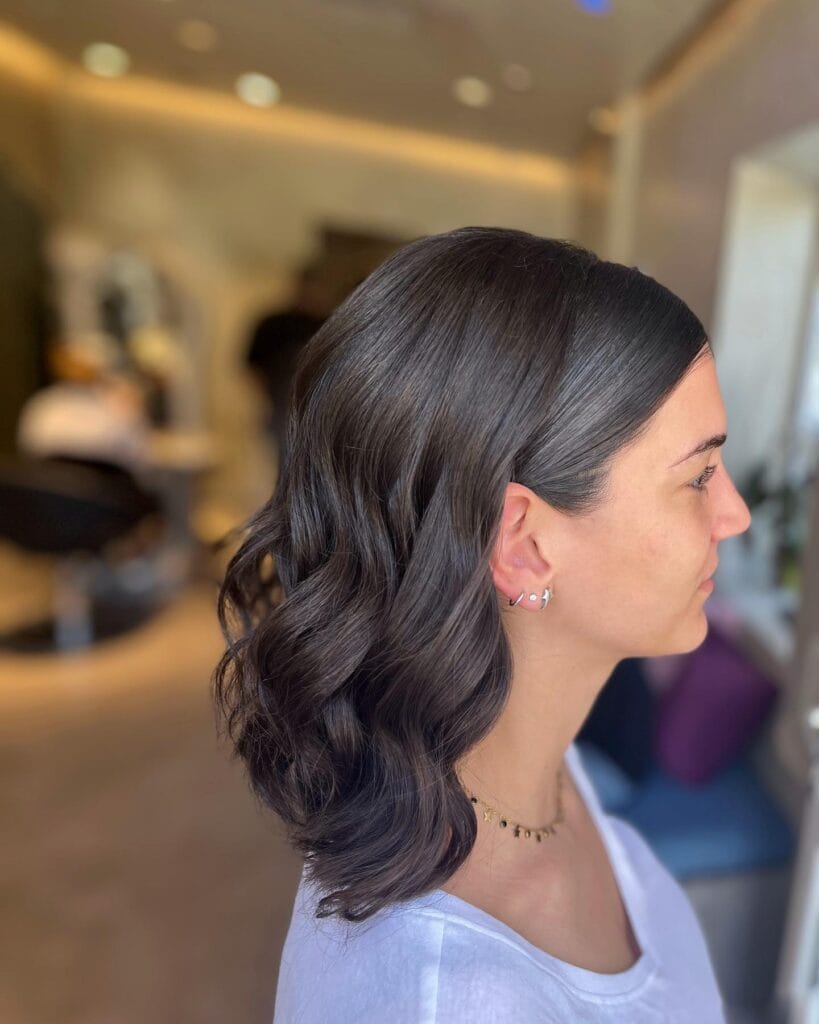 Shoulder length hair with soft waves and light volume.