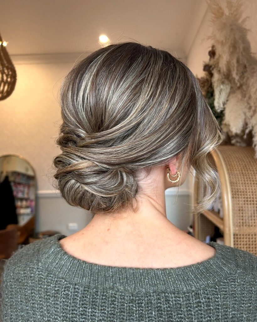 Sleek low knot with a wrapped section and smooth polished finish.