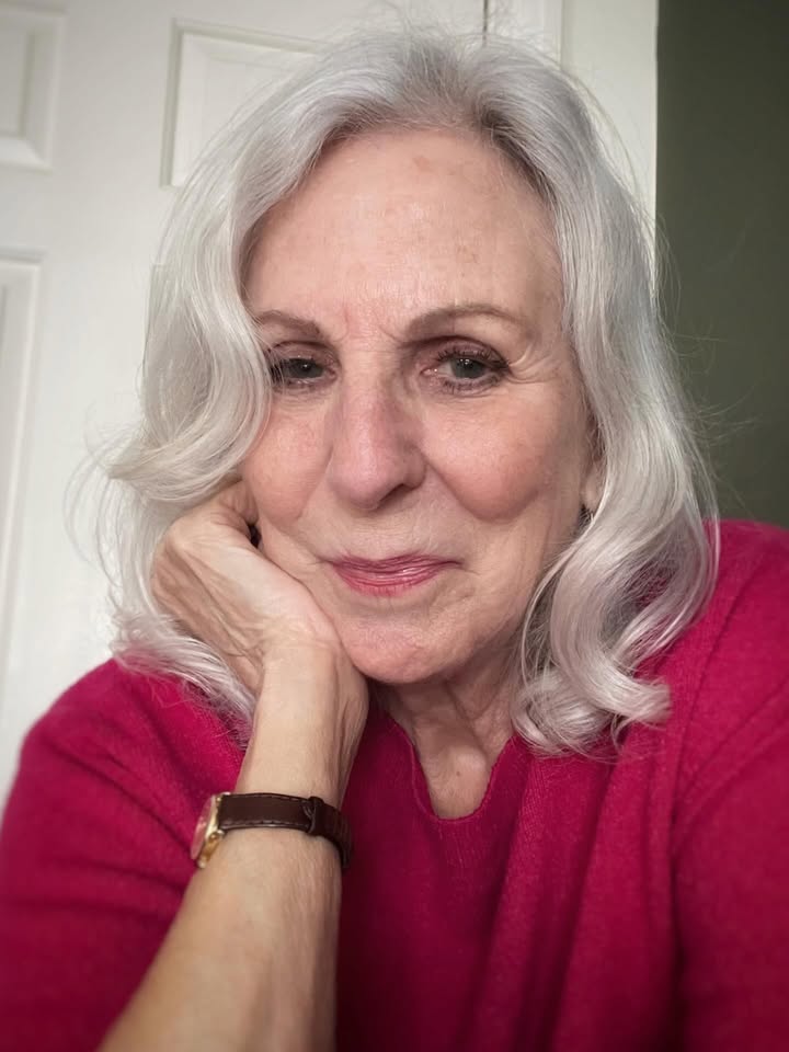 Medium length silver wavy hair with soft side swept bangs and natural shine.