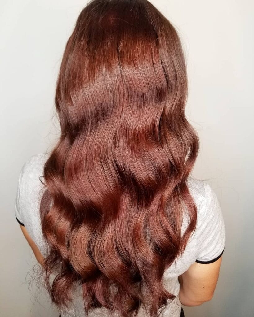 Long copper hair with soft defined waves and a warm glossy finish.
