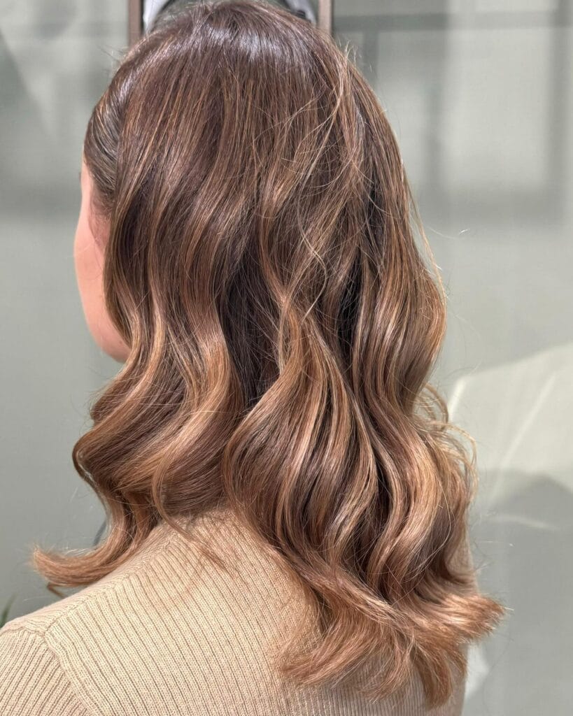 Long brunette hair with gentle soft waves and natural movement.