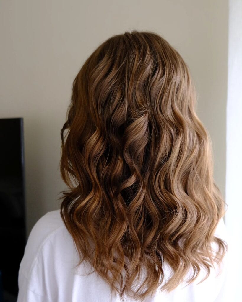 Long brunette hair with defined waves and full flowing shape.