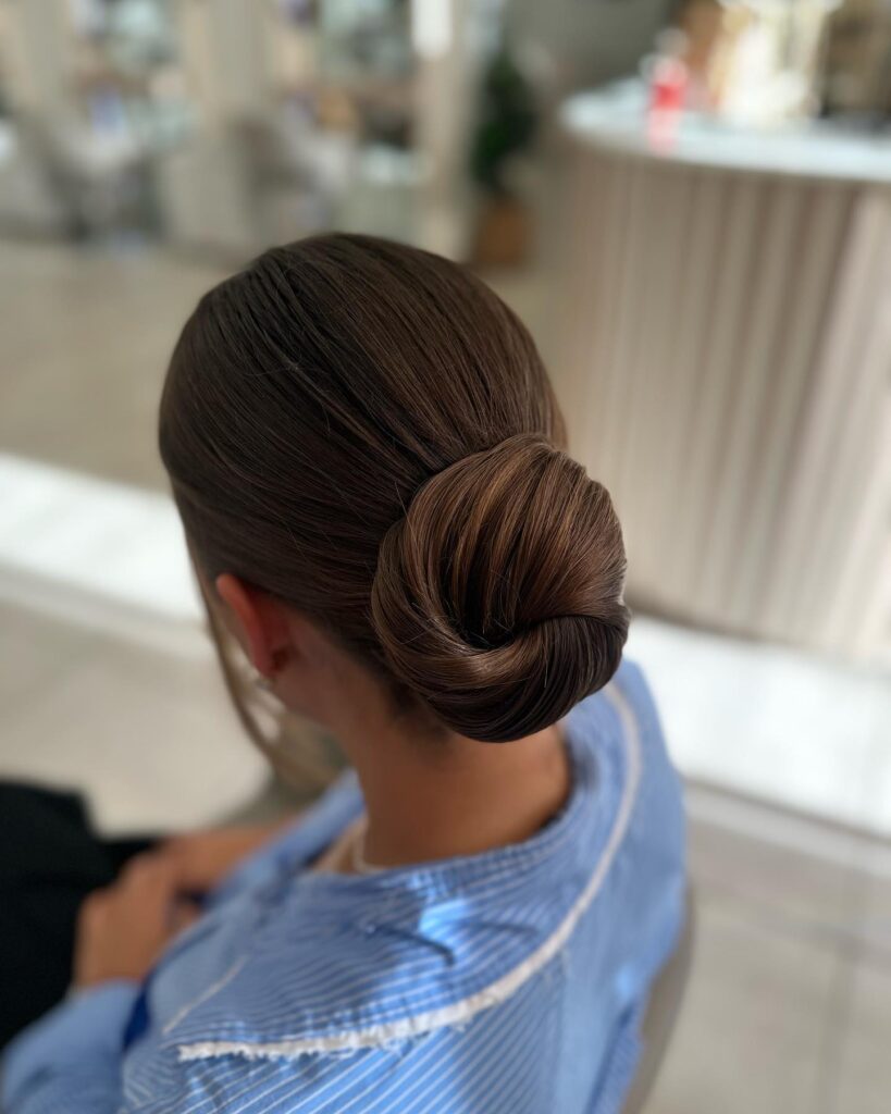 Soft twisted bun with natural texture and a relaxed low shape.