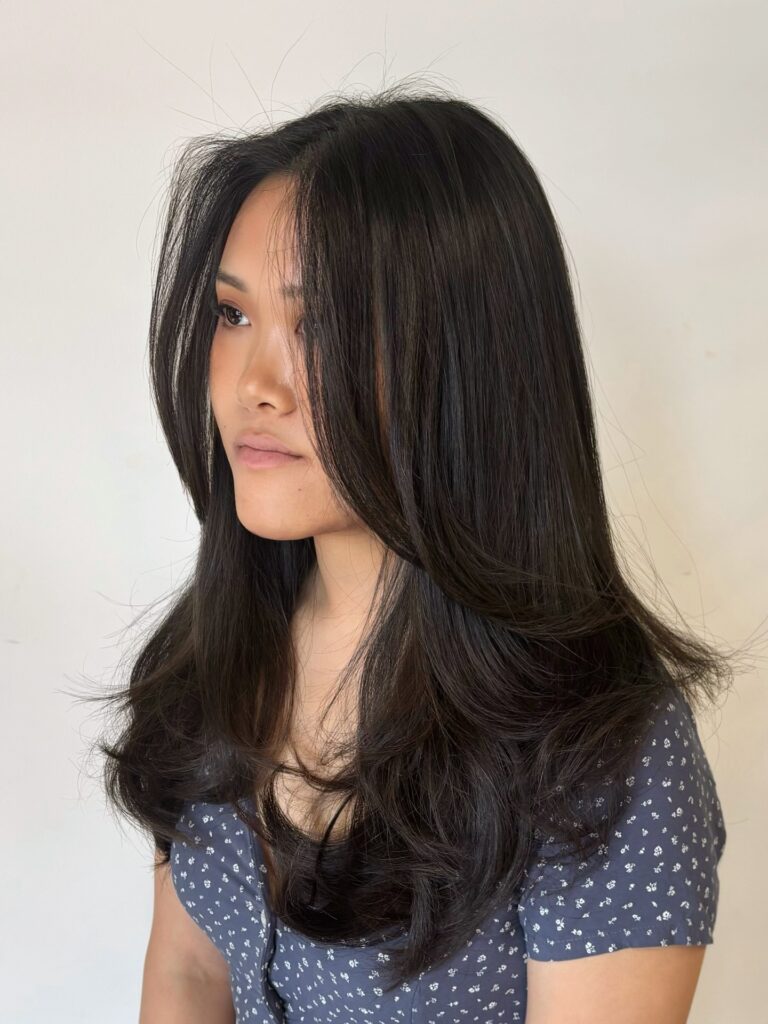 Medium length layered hair with smooth texture and softly flipped ends.