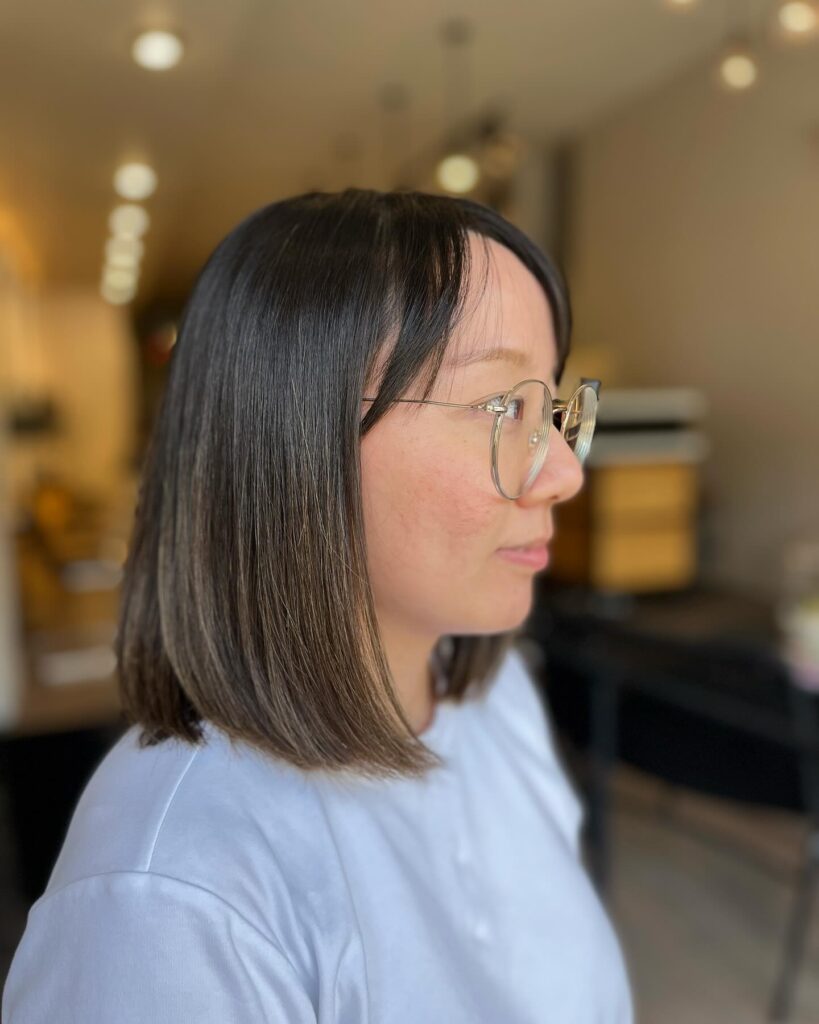 Straight brown bob haircut with a soft inward curve and a natural everyday finish.