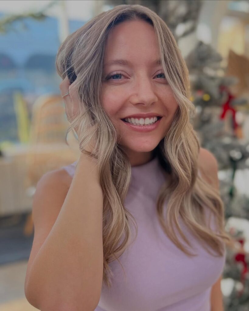Medium length blonde hair with soft beachy waves and natural texture.