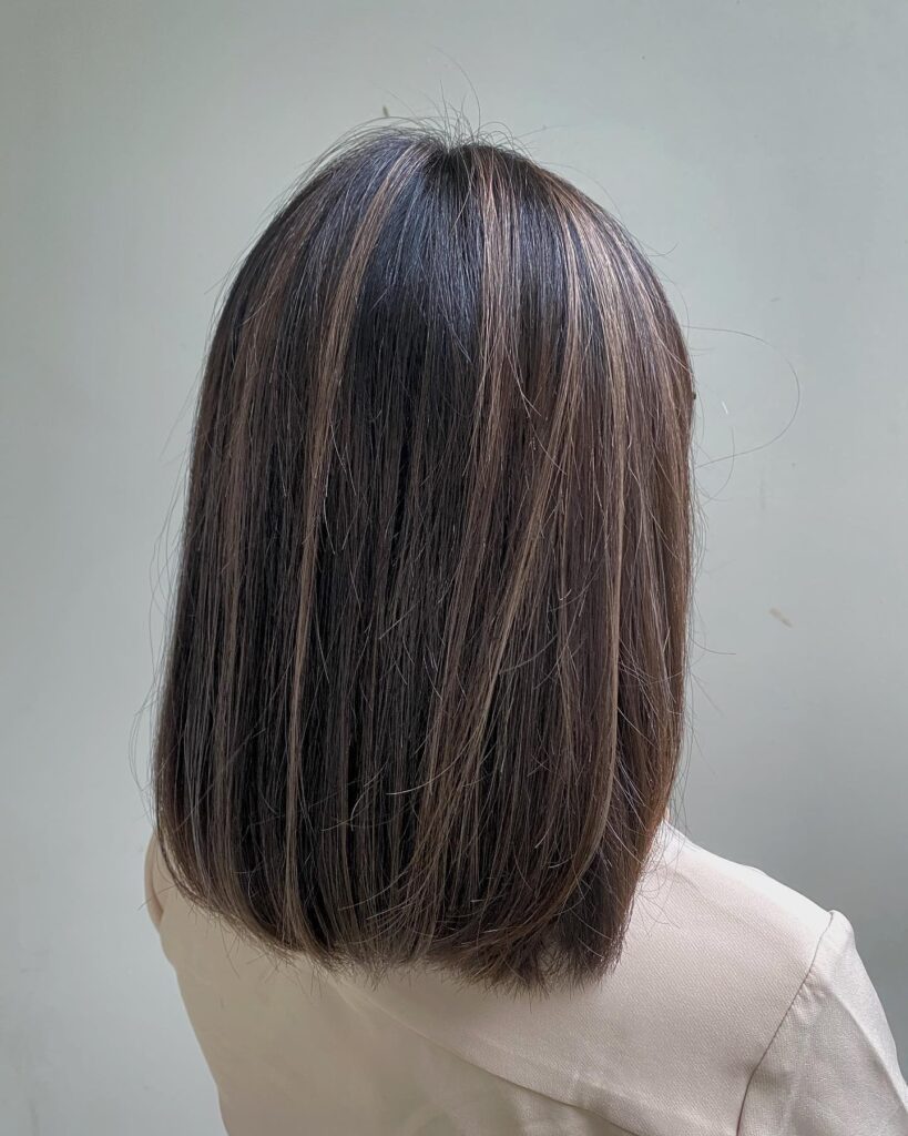 Medium length straight blunt haircut with clean even ends and natural shine.