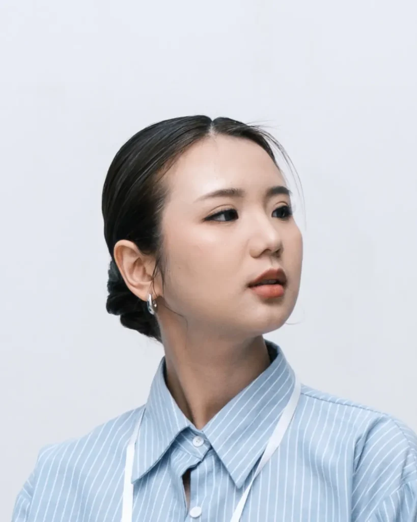 Sleek low bun with hair tightly pulled back and smooth clean finish.