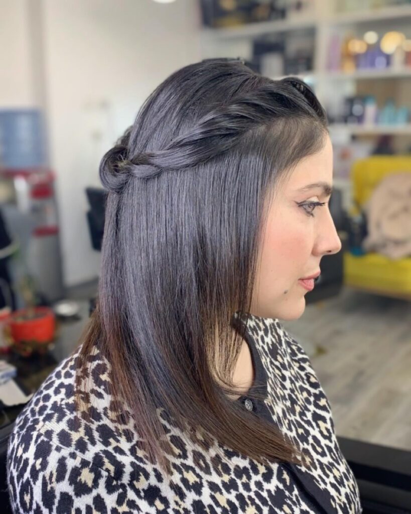 Straight shoulder length hair with a soft half up twist pinned at the back and sleek smooth finish.