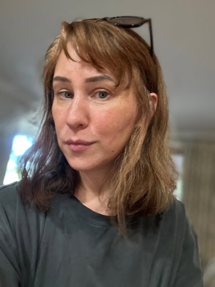 Shoulder length straight light brown hair with soft natural bangs and a relaxed finish.