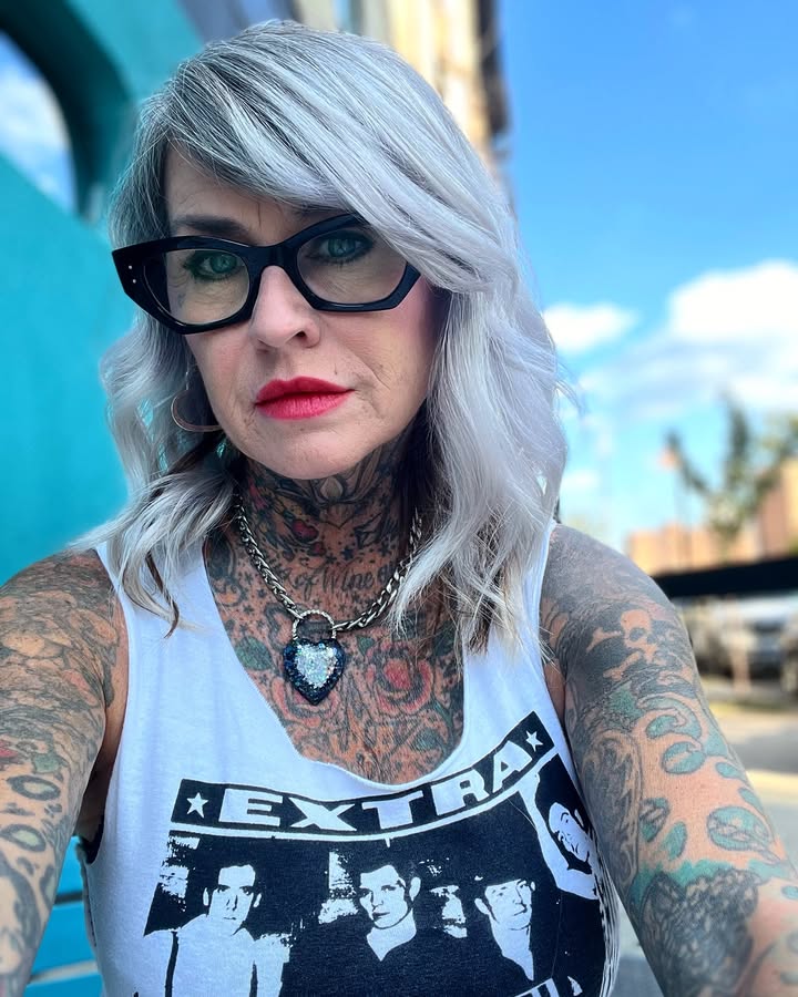 Silver lob with side swept bangs styled neatly with bold glasses.