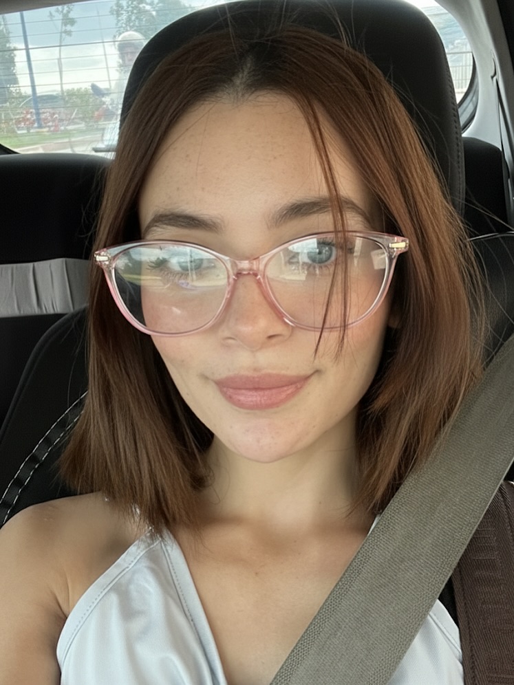 Chin length blunt bob with curtain bangs styled neatly with glasses.