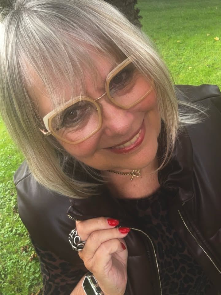 Silver shoulder length lob with full soft bangs styled above glasses.