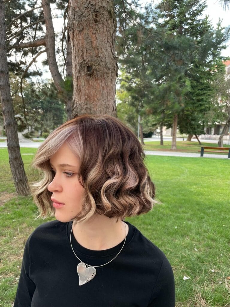 Short light brown bob with defined vintage-style waves.