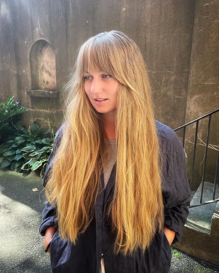 Extra long straight hair with soft fringe and smooth natural finish.