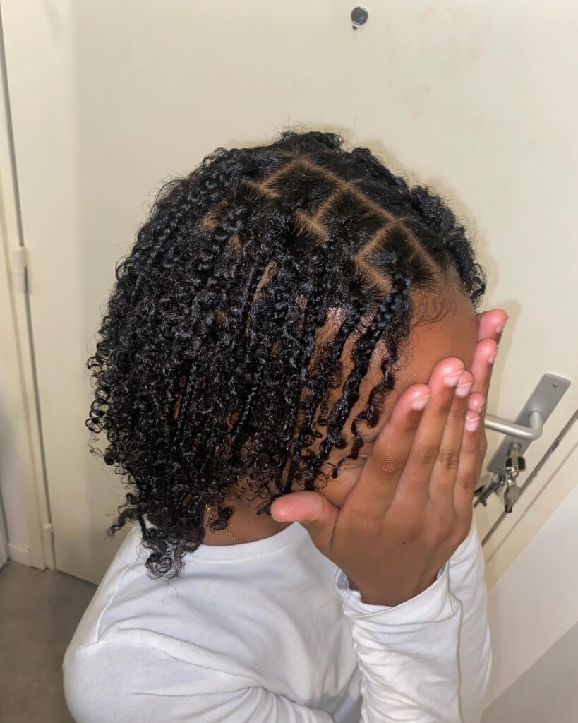 Defined twist out hairstyle with neat parts and visible coily texture.