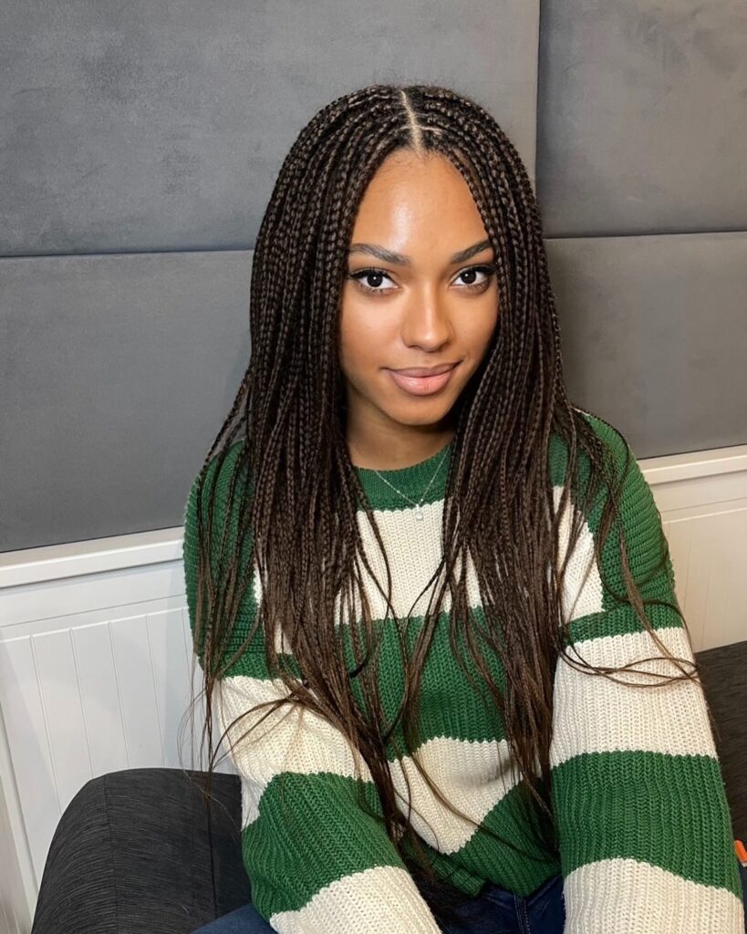 Long micro braids with a middle part and smooth even length.