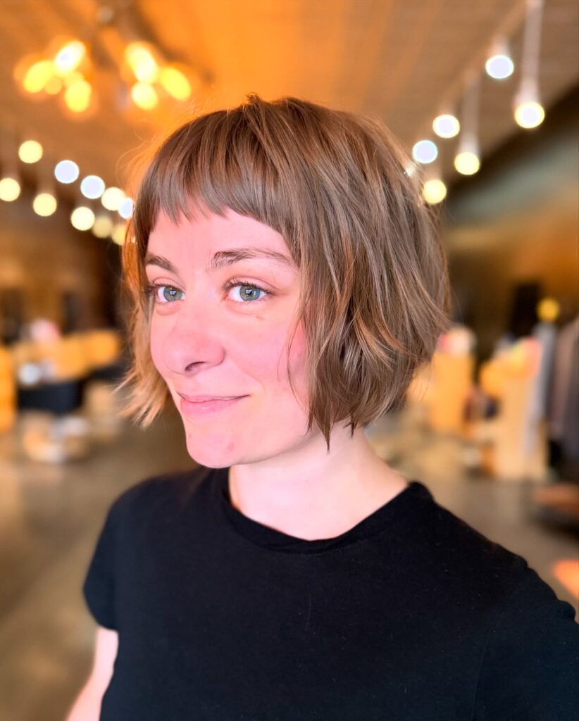 Short layered bob with choppy texture and a short micro fringe for a playful finish.