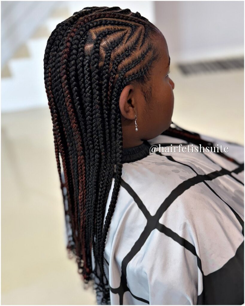 Long feed in braids with geometric parting and subtle color accents