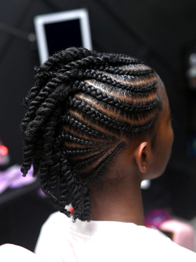 Side swept cornrow braids with curved pattern and voluminous braided ends
