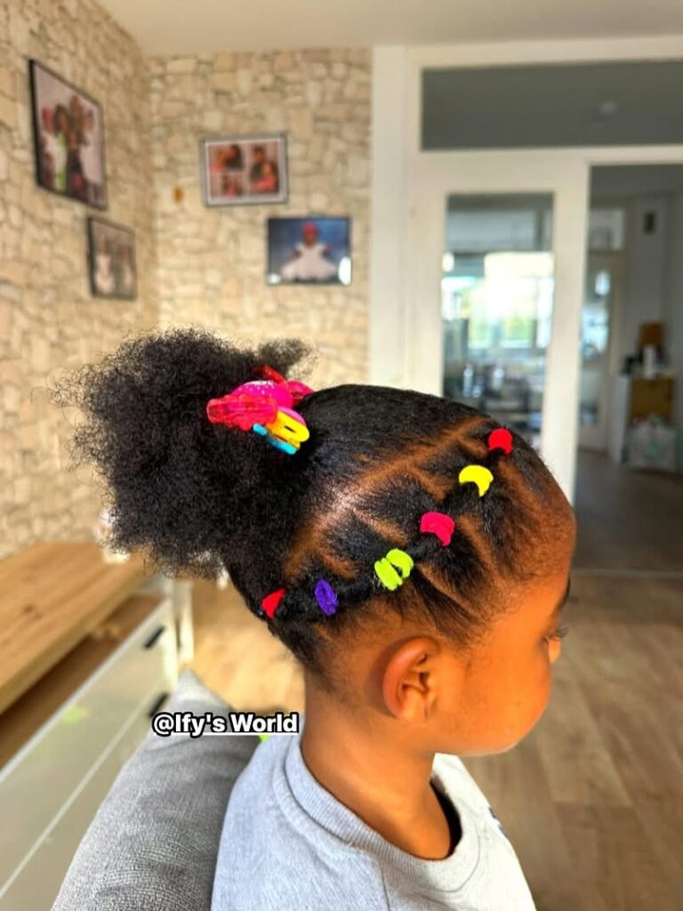 Side rubber band hairstyle with colorful bands leading into a high natural puff.