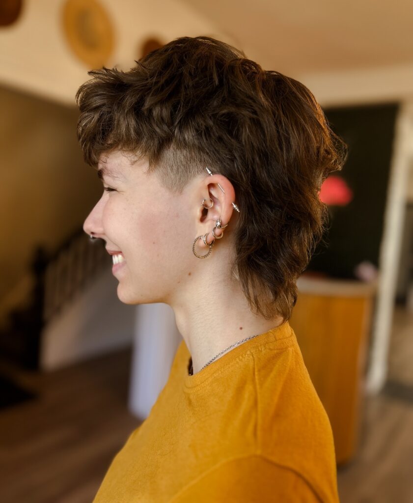 Short tomboy mullet with tapered sides and longer wavy back