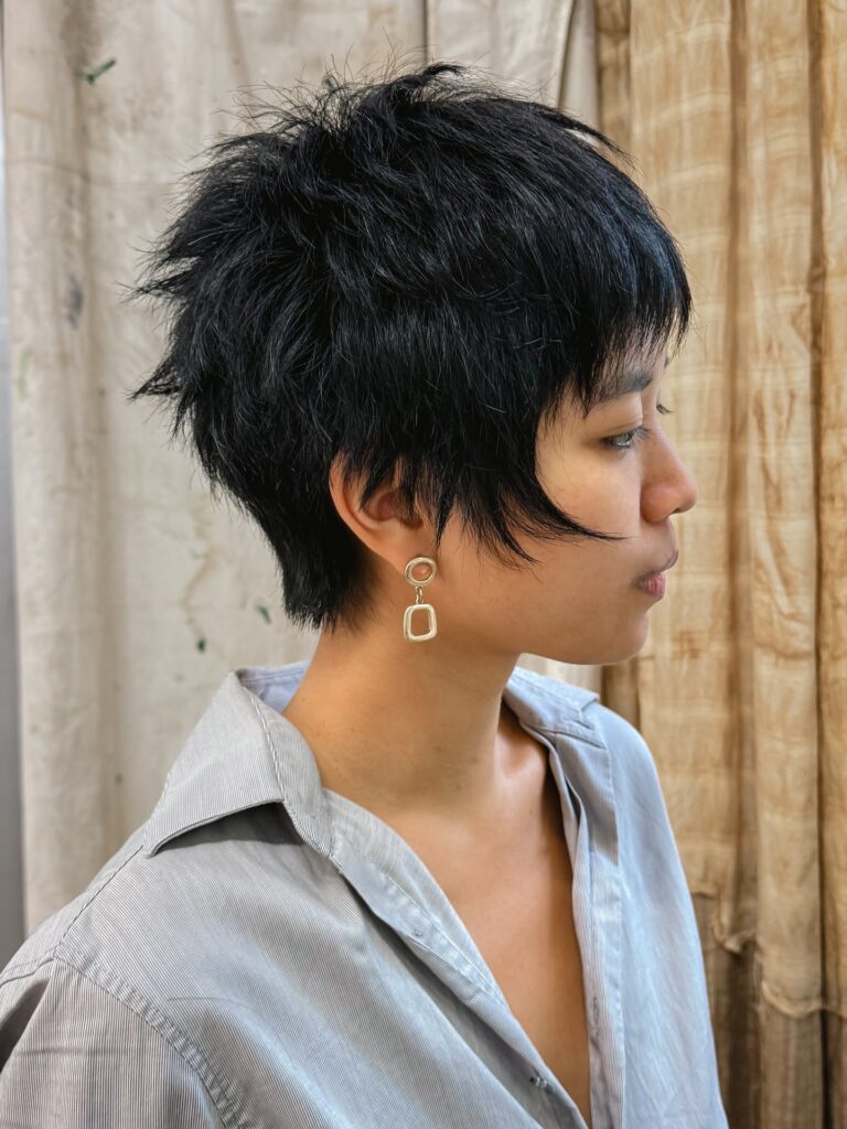 Short black tomboy pixie with feathered layers and soft texture