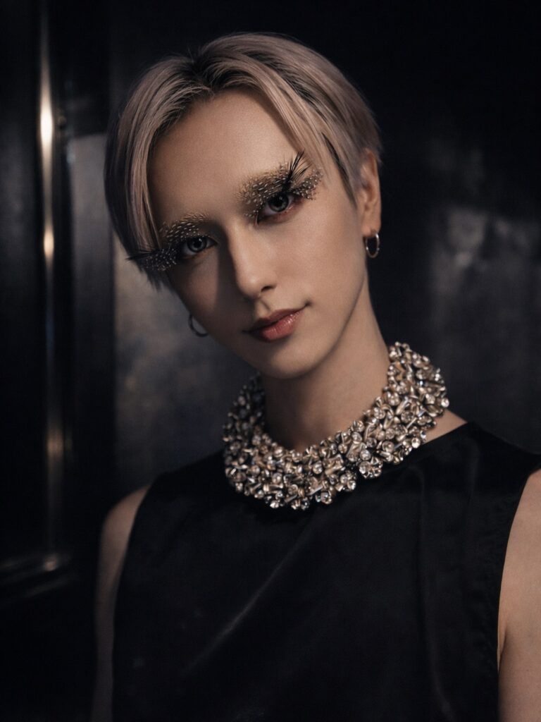 A woman with a short soft tomboy crop featuring a side swept fringe and natural light brown hair.