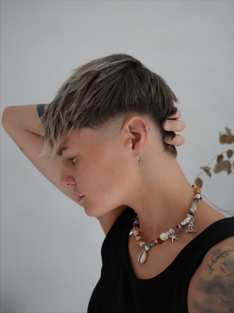 A woman with an ultra short buzz cut featuring even length and soft natural texture.