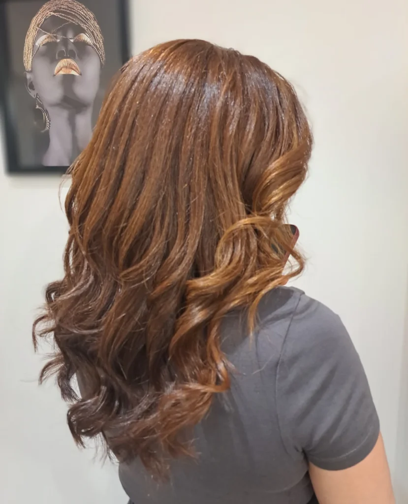 Long chocolate brown hair with soft loose waves and subtle highlights.