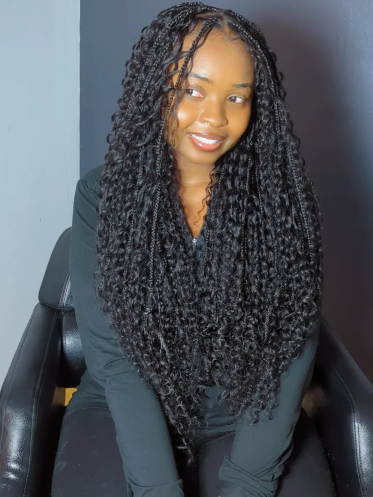 A woman with long passion twists featuring soft curly texture and full volume.