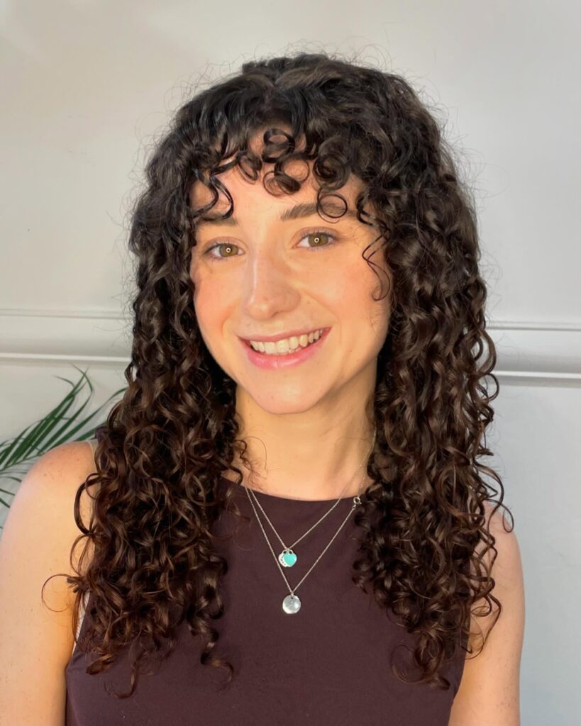 Tight natural ringlet curls with a short curly fringe and lots of volume.