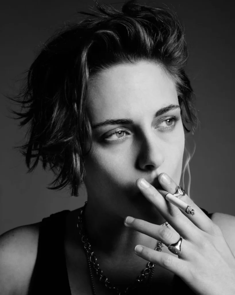 A woman with a short textured tomboy haircut featuring tousled layers and voluminous lifted top.