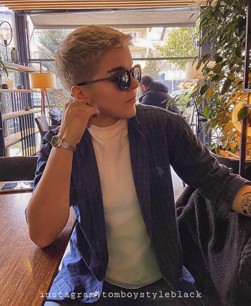 An ultra short blonde tomboy crop with closely clipped sides and soft texture on top.