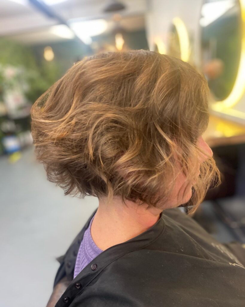A short wavy brown bob with soft layers and natural volume throughout.