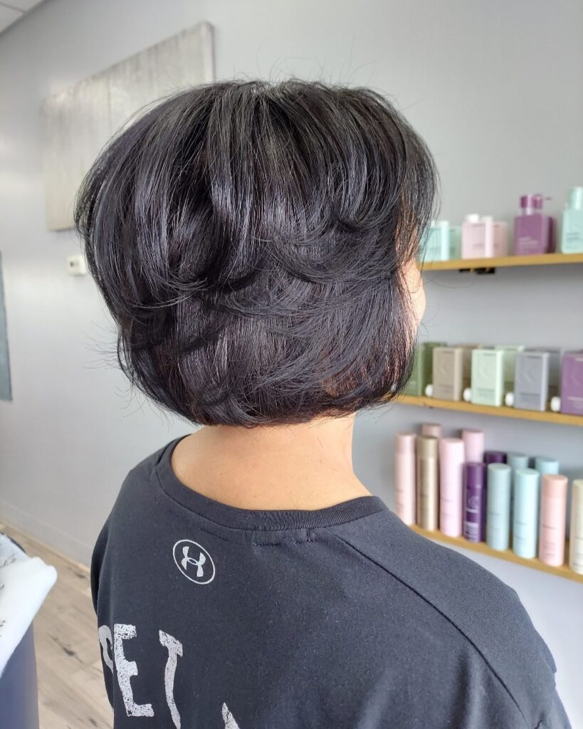 A short brunette bob with rounded layers and natural volume at the back.