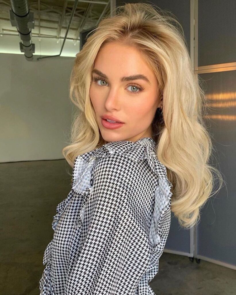 Bright icy blonde hair styled with root volume and loose glamorous waves.