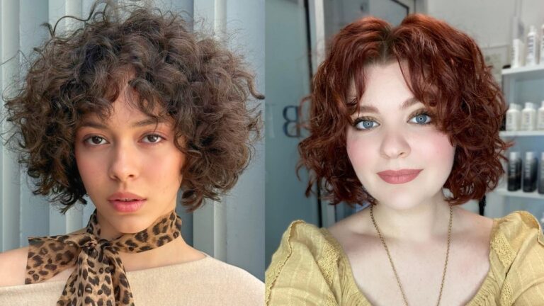 20 Short Curly Hairstyles for Women With Defined Texture and Easy Volume A woman with light eyes smiling, featuring a short auburn-red curly bob with volume and soft curly bangs.