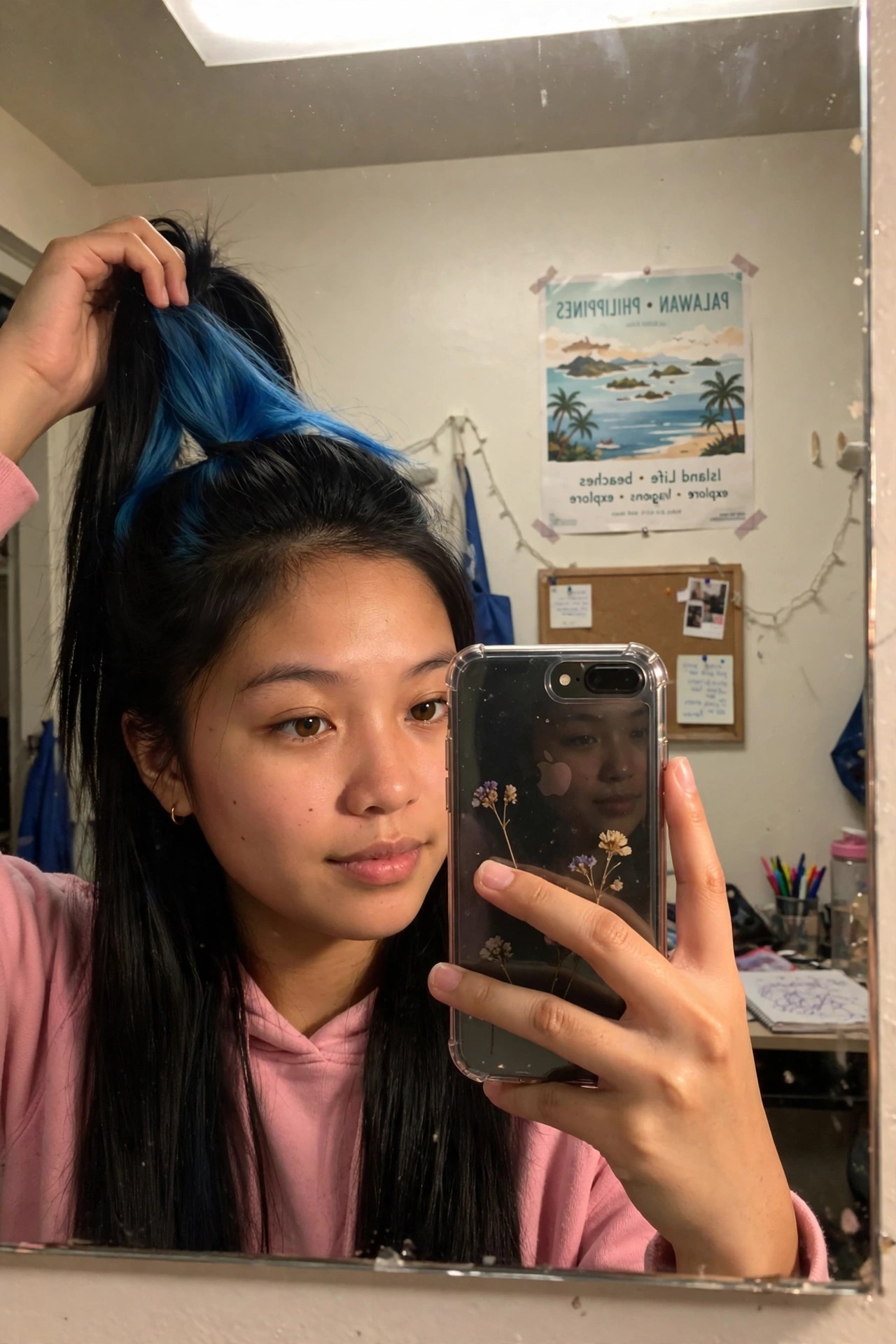 Close mirror selfie showing long black hair with bright blue sections pulled into a high ponytail.